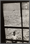 James Baldwin in abandoned lot amid rubble