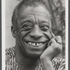 James Baldwin smiling in headshot