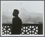 James Baldwin in profile with minarets