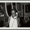 James Baldwin talking on telephone