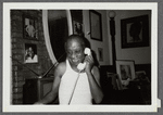 James Baldwin talking on telephone