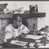 James Baldwin writing at desk