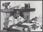 James Baldwin writing at desk