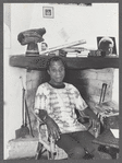 James Baldwin leaning back with cigarette