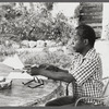 James Baldwin in checkered shirt marking pages