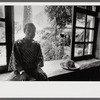James Baldwin sitting at window