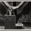 James Baldwin at podium with two microphones