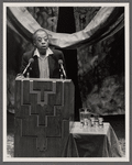 James Baldwin at podium with two microphones