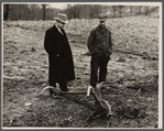 Resettlement Administration representative and rehabilitation client looking over farm machinery. Jackson County, Ohio.