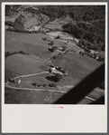 Air view. Farm with town of Lincoln in distance. Lincoln, Vermont.