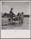 Old farmhand in his homemade buggy. Lincoln, Vermont.