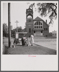 Old man and his wife preparing their popcorn roaster in front of the town hall. Bristol, Vermont.