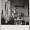 Farm woman washing clothes in her motor-driven washing machine. Near Lincoln, Vermont.