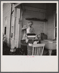 Farm woman washing clothes in her motor-driven washing machine. Near Lincoln, Vermont.