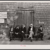 The "Sand Bar Club," a bench on the waterfront main street which is occupied all day by fishermen, unemployed fishermen and other residents with nothing to do; here they gossip, whittle, and make remarks about passing tourists. Provincetown, Massachusetts