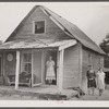 [Woman and two young girls standing in front of dilapidated house; probably Cape Cod, Massachusetts.]
