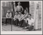 Fishermen hanging around in front of workshop of former fisherman who is now a builder of pleasure boats for tourists. Provincetown, Massachusetts.