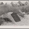 Commemorative plaque on Corn Hill where, supposedly, the Pilgrims first found sweet corn. In the background, tourist houses. Provincetown, Massachusetts.