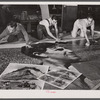 Workers working on installation of war bond mural. Grand Central Station, New York, New York.