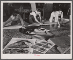 Workers working on installation of war bond mural. Grand Central Station, New York, New York.
