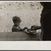 Small boy at mealtime in the camp for white flood refugees, Forrest City, Arkansas.