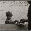 Small boy at mealtime in the camp for white flood refugees, Forrest City, Arkansas.