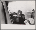 Woman at mealtime in the camp for white flood refugees, Forrest City, Arkansas.