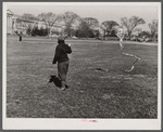 Boy playing with kite in front of Washington Monument. Washington, D.C.