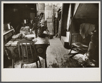 Hovel home of two Negro families, Washington, D.C. Near ice chest is the privy, although unseen in this picture. A recent relief visit accounts for the food on the table.