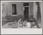 Slum front yard playground, Washington, D.C. Such is the front yard available to these two youngsters to play in.