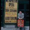 Unidentified man with a poster for a Metropolitan Opera tour of Don Giovanni