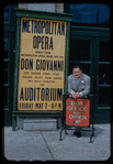 Unidentified man with a poster for a Metropolitan Opera tour of Don Giovanni