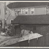 Garage in foreground is home of white family, man and wife. Manville, New Jersey.