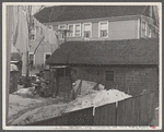 Garage in foreground is home of white family, man and wife. Manville, New Jersey.