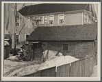 Garage in foreground is home of white family, man and wife. Manville, New Jersey.