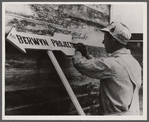 Carpenter or painter at work on the Berwyn project,  [Greenbelt,] Maryland.