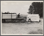 Unloading lumber at Berwyn [i.e. Greenbelt], Maryland.