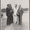 Resettlement Administrator R.G. Tugwell (in white), with his aides John O. Walker, John L. Lansill, and Frank Schmidt, inspects progress made at Greenbelt, Maryland,