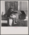 Arlington, Virginia. A girl in her room playing a phonograph at Arlington Farms, a residence for women who work in the government for the duration of the war.