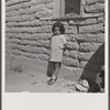 The mother said, "I keep her dressed nice every day because she is the only girl I've got." Great Western Sugar Company's beet sugar workers' colony at Hudson, Colorado.