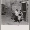 The mother said "I keep her dressed nice every day, because she is the only girl I've got." Great Western Sugar Company's beet sugar workers' colony at Hudson, Colorado.
