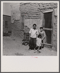 The mother said "I keep her dressed nice every day, because she is the only girl I've got." Great Western Sugar Company's beet sugar workers' colony at Hudson, Colorado.
