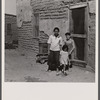 The mother said "I keep her dressed nice every day, because she is the only girl I've got." Great Western Sugar Company's beet sugar workers' colony at Hudson, Colorado.