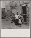 The mother said "I keep her dressed nice every day, because she is the only girl I've got." Great Western Sugar Company's beet sugar workers' colony at Hudson, Colorado.