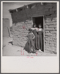 Two sisters and brother before their house. Great Western Sugar Company's beet sugar workers' colony at Hudson, Colorado. The father is dead, and the girls don't attend school because they're "too old," and the boy because he is "sick all the time".