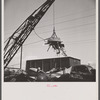 Washington, D.C. Scrap salvage campaign, Victory Program. Electro-magnet loads metal scrap onto freight car in wholesale junkyard.