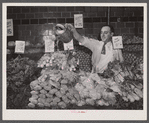 Washington, D.C. Watering vegetables to keep them fresh in the Giant Food shopping center on Wisconsin Avenue.