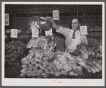 Washington, D.C. Watering vegetables to keep them fresh in the Giant Food shopping center on Wisconsin Avenue.