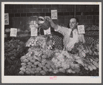 Washington, D.C. Watering vegetables to keep them fresh in the Giant Food shopping center on Wisconsin Avenue.