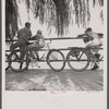 Washington, D.C. Sunday cyclists watching sailboats at Haines Point.